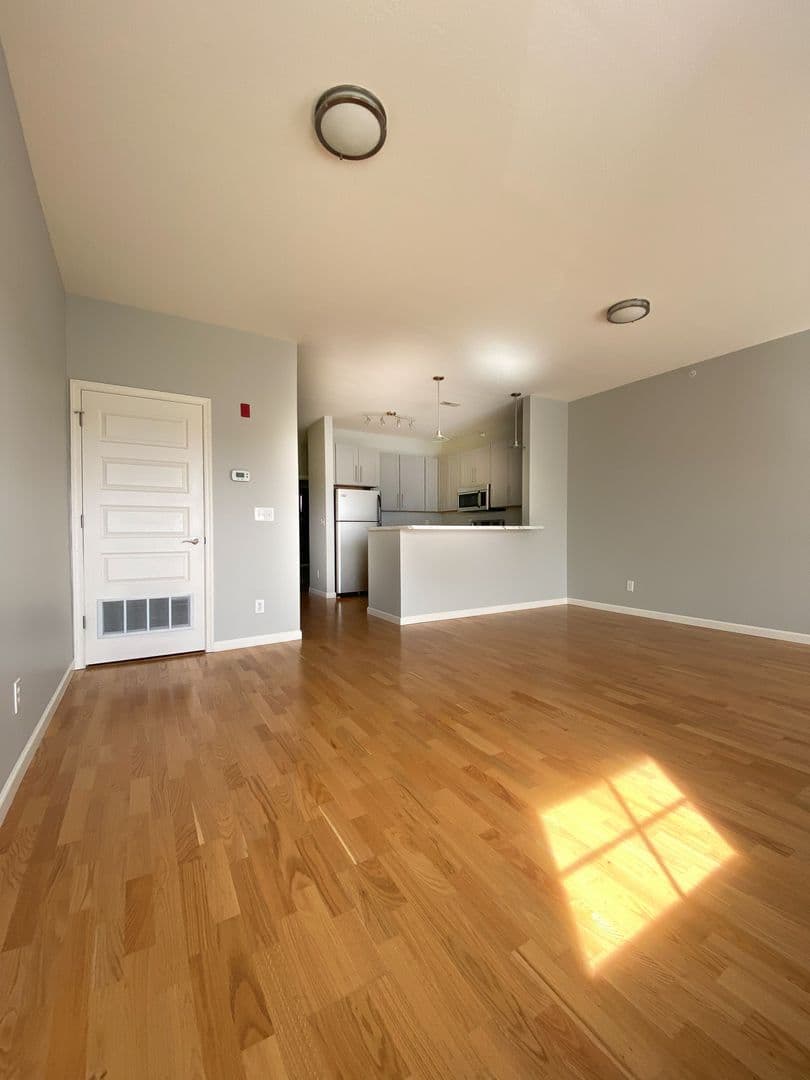Sunlit living room with hardwood floors at Cedar Bluff