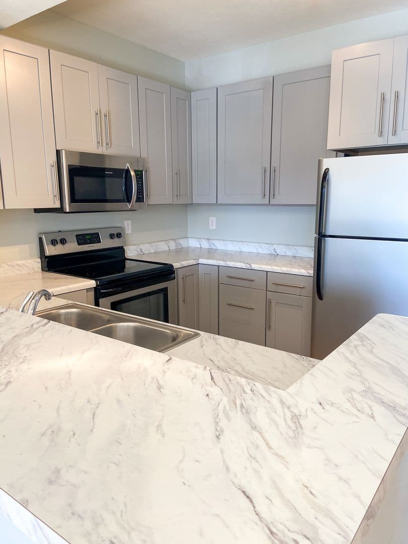 Kitchen with marble-style countertops and stainless steel appliances